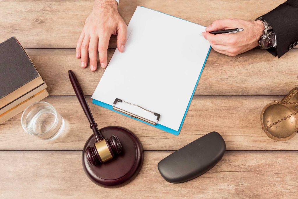 A lawyer’s desk with legal documents, a gavel, and scales of justice, representing Judith Ramos, Attorney at Law’s commitment to family law cases in Miami, Florida.